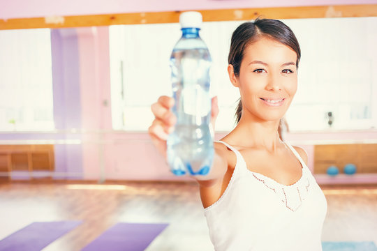 Happy asian woman fitness exercise holding natural water