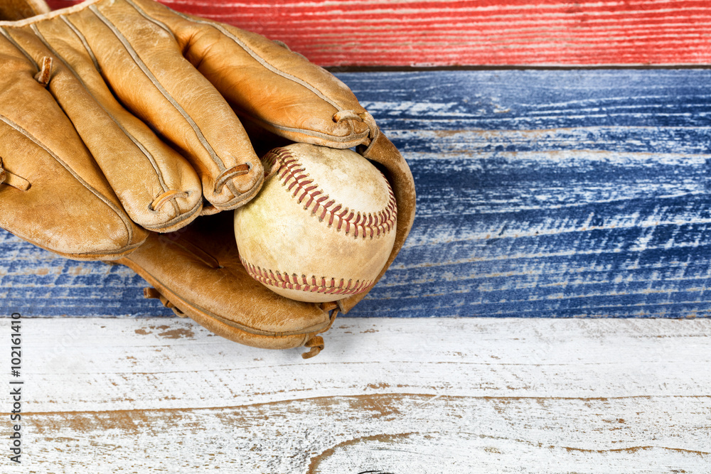 Wall mural worn baseball mitt and ball on faded boards painted in USA colors