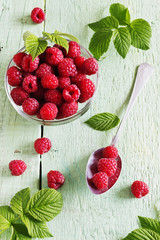 ripe juicy raspberries in a glass bowl