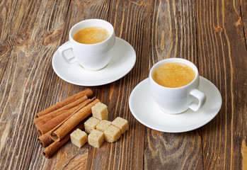Two cup of hot esspresso, cinnamon and sugar cane