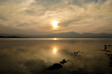 Sunset on the lake against the sky in the clouds.