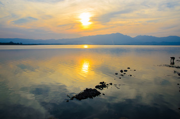 Sunset on the lake against the sky in the clouds.