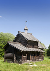 Ancient wooden church on a forest glade. Russia.