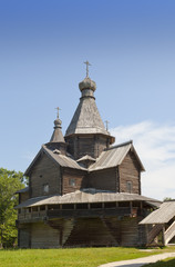 Ancient wooden church on a forest glade. Russia.