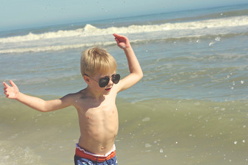 Happy Young Child Playing in the Ocean