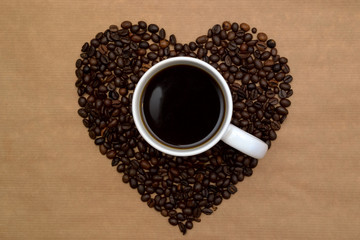 Hearts shaped coffee beans and a cup of coffee