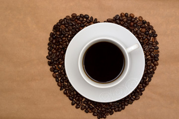 Hearts shaped coffee beans and a cup of coffee, Top view