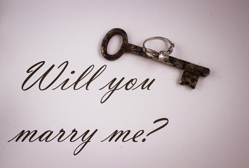 old rusty key and silver present ring with diamond, will you mar