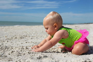 Cute Baby Girl  Playing in the Sand at the Beach