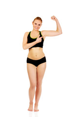 Young athletic woman showing muscles