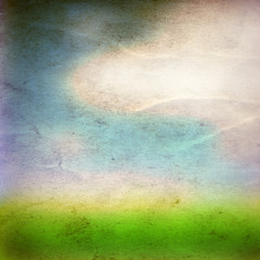 Conceptual green grass and sky old paper