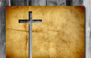 Old vintage Christian paper cross over wood wall background