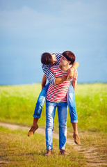 young male couple having fun at spring field