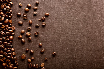 Roasted coffee beans on grey textile background