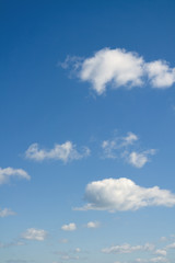 Fototapeta premium Cloudscape over horizon. Blue sky and white clouds.
