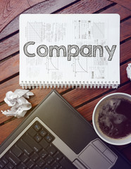 work place - table with notebook with note about:  company