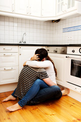 Romantic couple kissing in the kitchen.