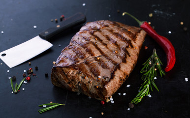 Grilled Beef Steak with spices, rosemary and chili peppers