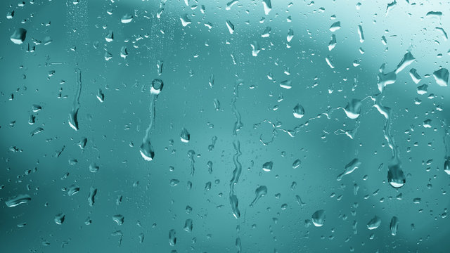 Beautiful blue abstract raindrop pattern on a window at rainy day. Lovely metal look effect used.