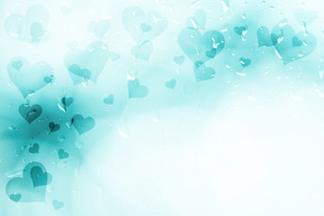 Bright blurry cyan blue colored Valentine's Day Hearts illustration on bright wet window with droplets. Beautiful heart symbols with copy space background.