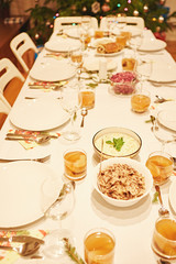 Table with festive food and Christmas tree