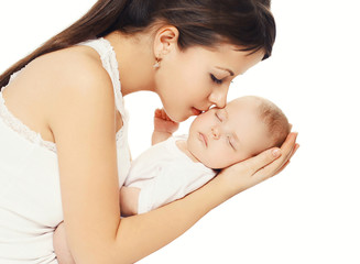 Happy loving mother kissing her baby holding on hands over white