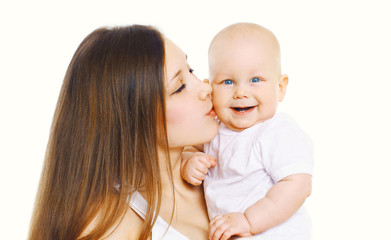 Portrait happy mother kissing her cute baby over white backgroun
