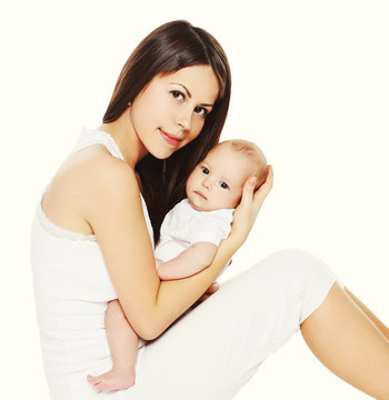 Portrait beautiful young mother and baby together on a white bac
