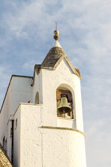 Fototapeta premium Belltower of the Trullo church in Alberobello, Italy