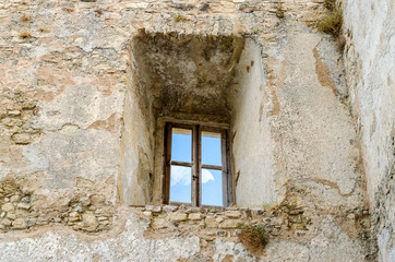 Fototapeta na wymiar Ancient window from the ruins of an old castle