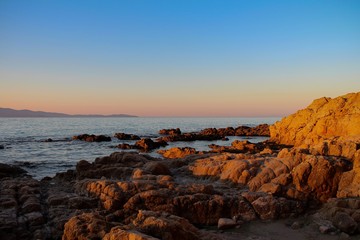 Sunrise with a view at a stony shore
