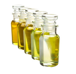 Avocado fruit oil, sesame seed oil, olive oil, grape seed oil and corn oil in vial glass bottle over white background