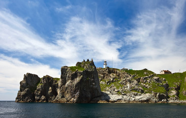 Naklejka premium Lighthouse on a steep cliff of Cape Gamow.