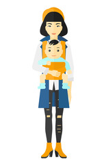 Woman holding baby in sling.