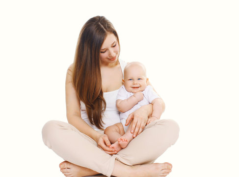 Happy young mother sitting with baby on a white background