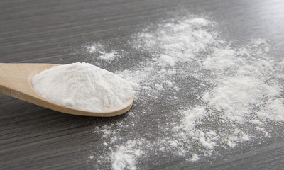 baking soda (sodium bicarbonate) in a wooden spoon