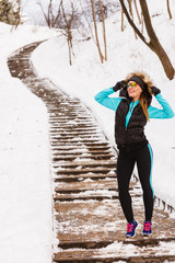 Female fitness sport model outdoor in cold winter weather