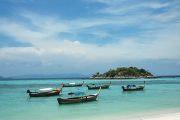 Fototapeta na wymiar Fishing boats on the sea with blue sky background, Li-Pe Thailan
