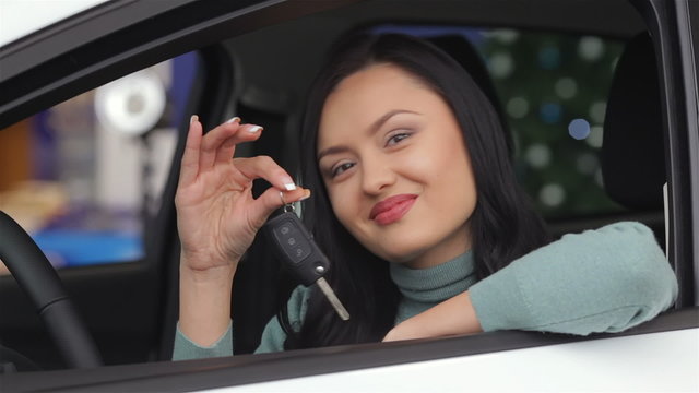 Smiling woman showing the car key