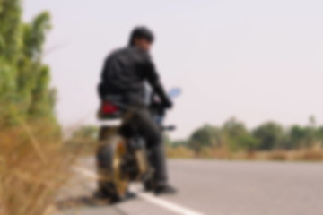 Biker man sits on a motorcycle 