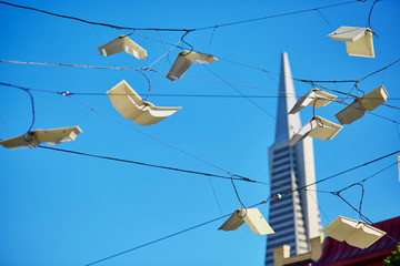 Flying books over blue sky in San Francisco, USA