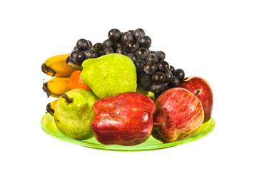 Mix fruit on green plate isolated on white background