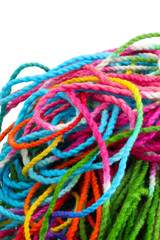 Tangled colorful sewing threads on white background.