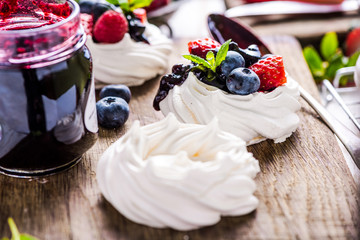 Close view on Pavlova decorated with berry fruits