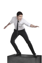 Asian business man surfing or riding the block