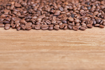 Close up a coffee beans on the wooden table