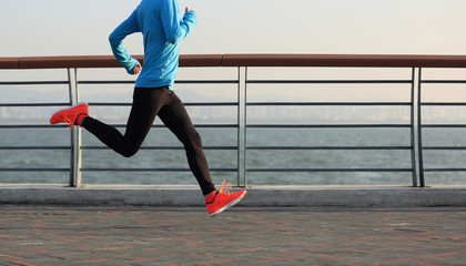 young fitness woman runner running at seaside