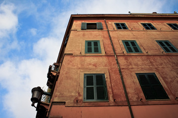 Orange building with green windows in Rome, Italy