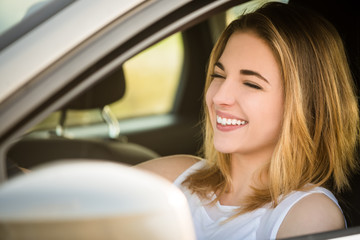 Fototapeta na wymiar Young woman driving car