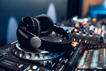 headphones on dj board in night club - obrazy, fototapety, plakaty